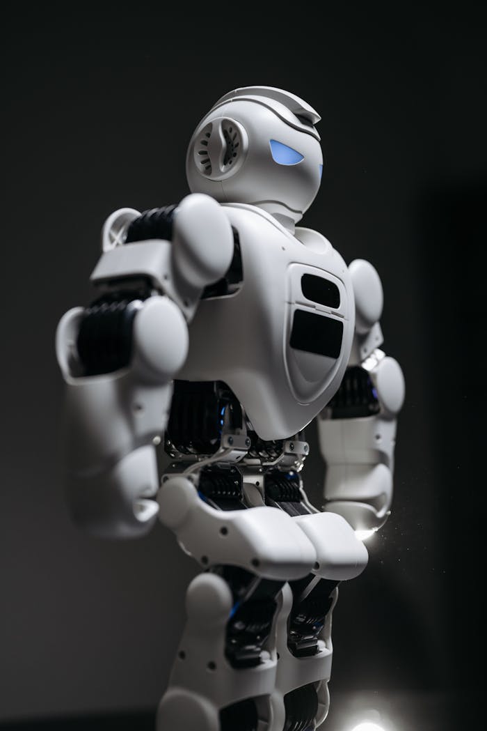 A detailed studio shot of a humanoid robot against a gray background, showcasing modern technology.